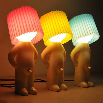 Shy little boy reading lamp