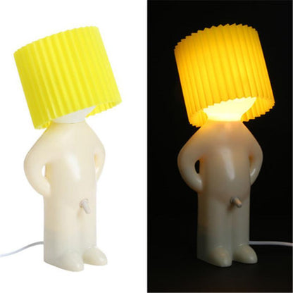 Shy little boy reading lamp